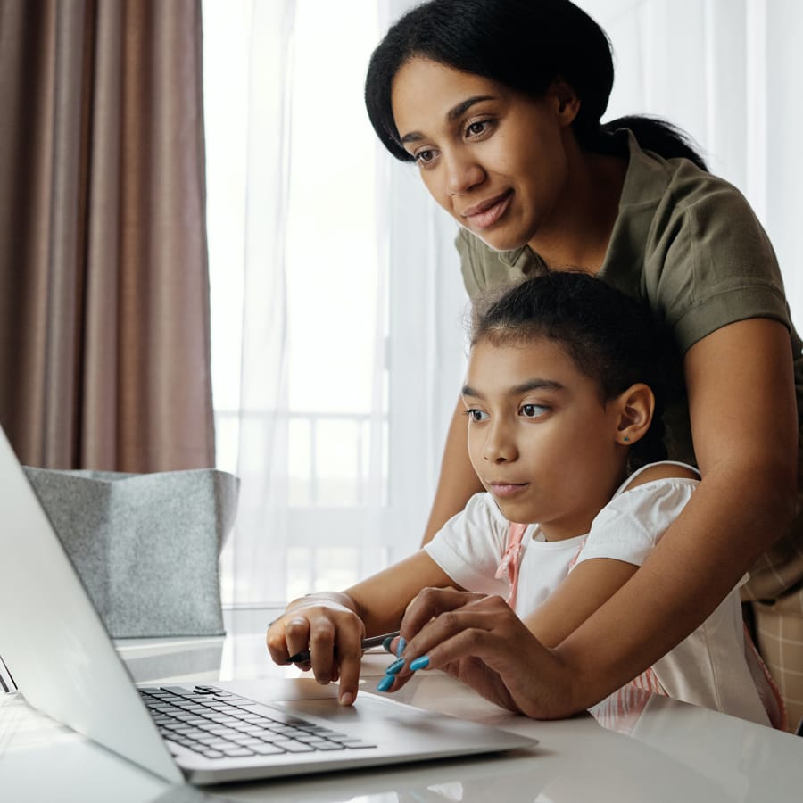 Mother helping daughter with home school tasks