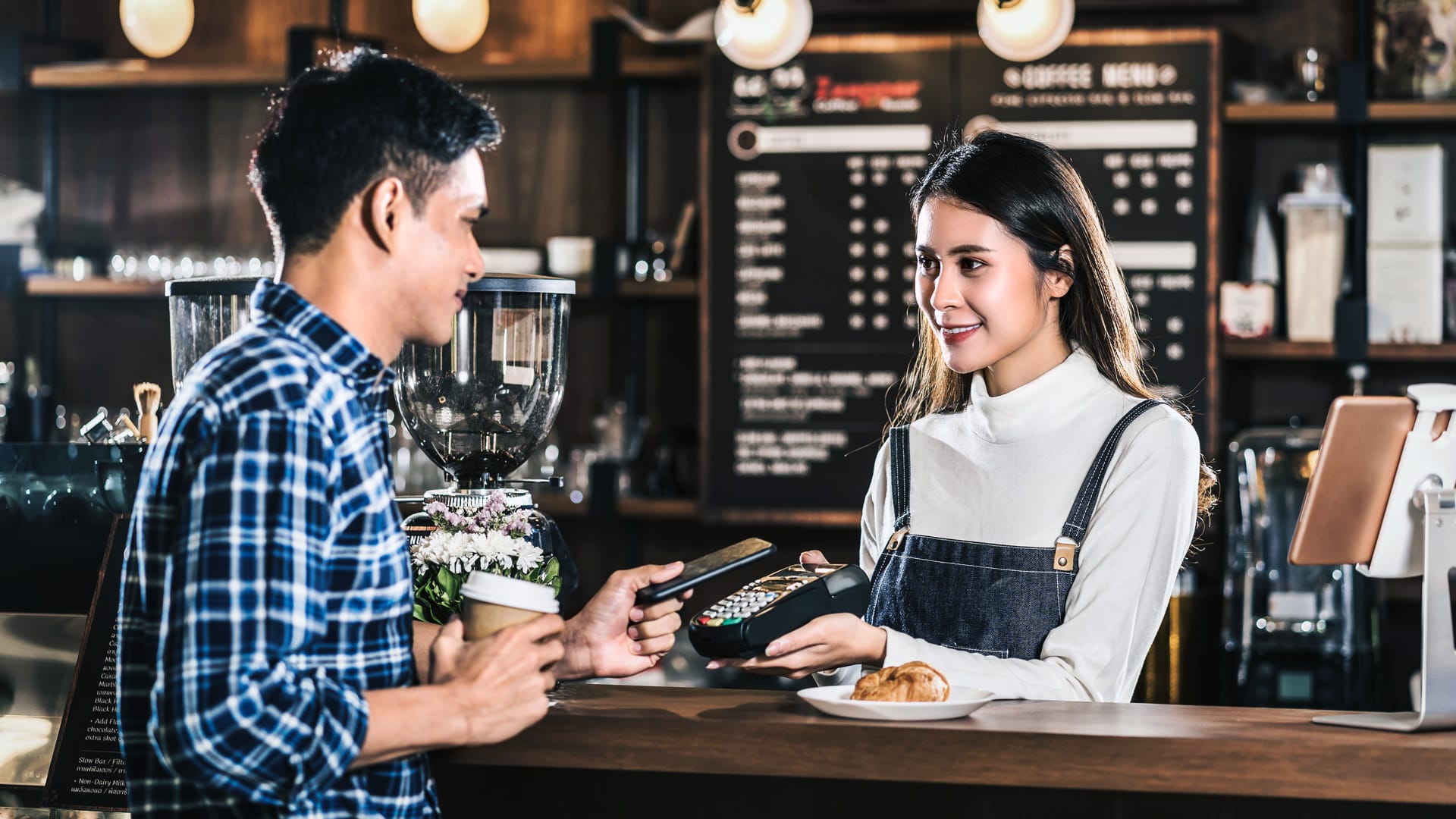 Business employee serving coffee to a customer