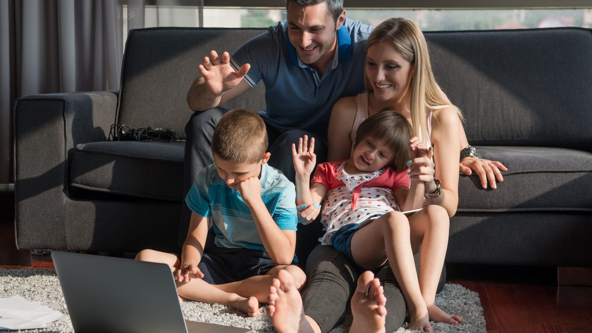 Family in front of laptop at home